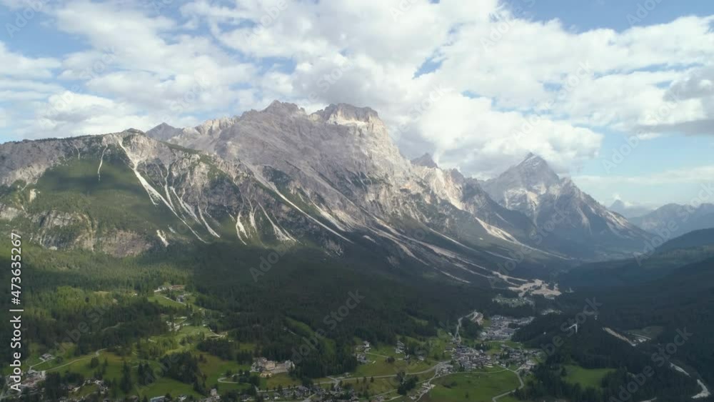 Aerial Forward Beautiful Shot Of Natural Rock Formations, Drone Flying Over Houses On Landscape - Dolomites, Italy Aerial Forward Beautiful Shot Of Natural Rock Formations, Drone Flying Over Houses On Landscape - Dolomites, Italy