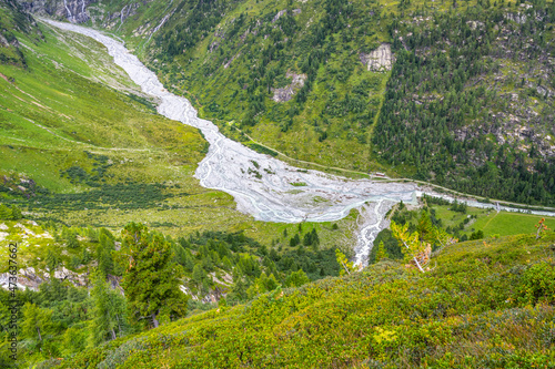 Narrow twisted rocky stream in alpine valley
