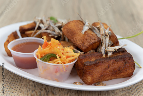 Fried Yucca root with garnished with dried fish and dipping sauce for a Latino food delight