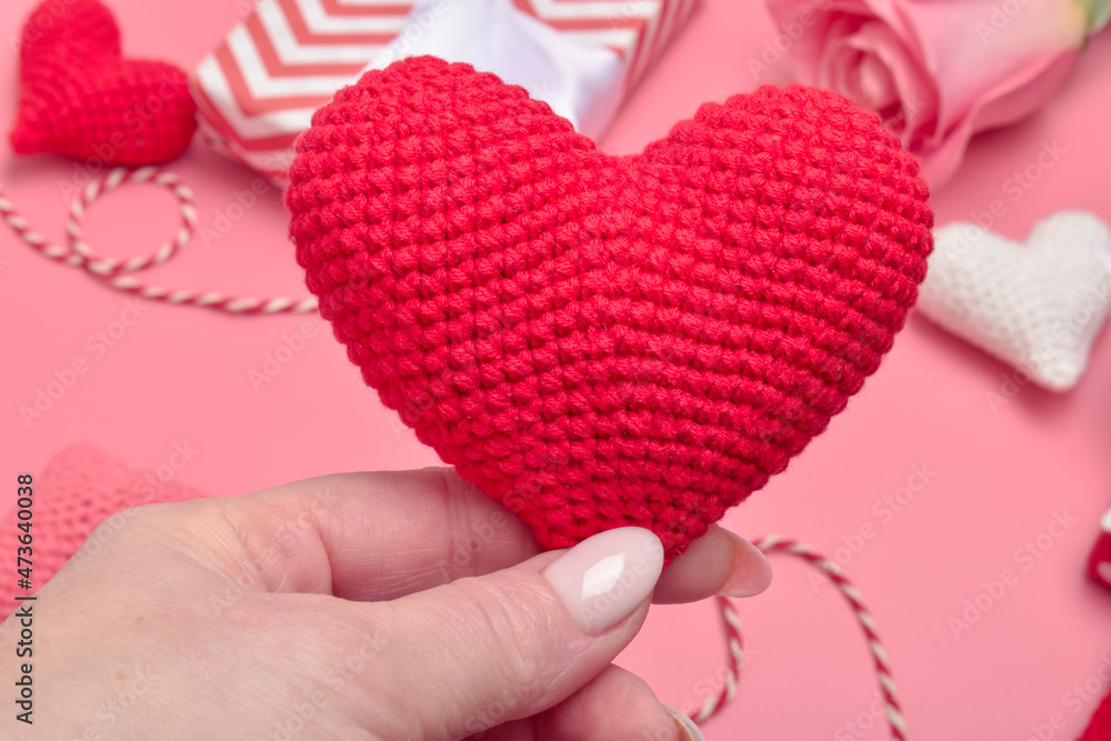 Fototapeta premium A red heart is in women's hands. Banner, Valentine's Day card.