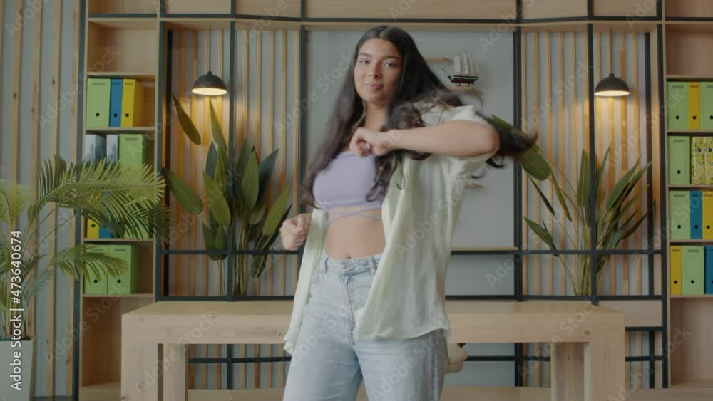 PHONE CAMERA POV, Mixed race teen girl recording trendy dance moves for social media account at home PHONE CAMERA POV, Mixed race teen girl recording trendy dance moves for social media account at home