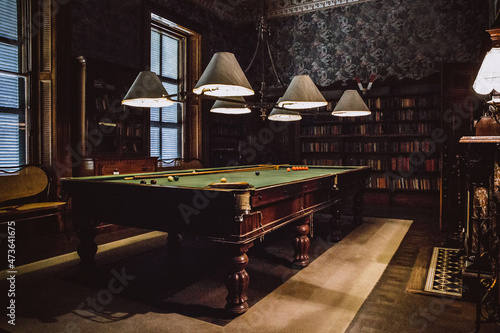 Snooker table setup with balls and pool cue in an old room photo