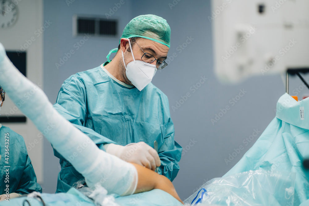 Orthopedic surgeon operating patient Orthopedic surgeon operating patient