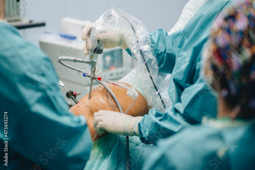 Surgeon with arthroscope operating patient photo