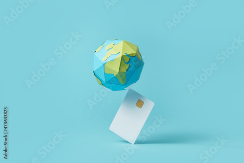 Paper globe balancing on debit card photo