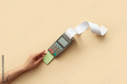 Woman inserting credit card in terminal photo