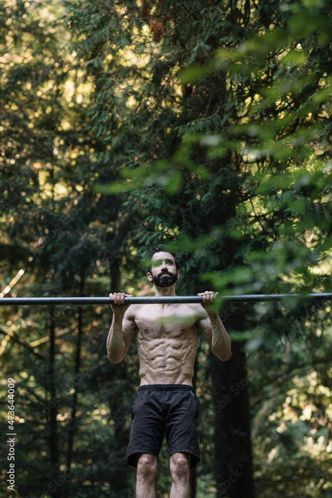 Young Man Exercising Outdoors In Nature on Young Man Exercising Outdoors In Nature on