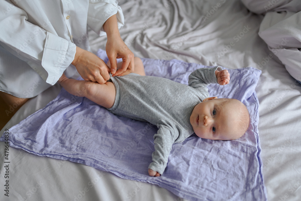 mom changes the baby's clothes mom changes the baby's clothes