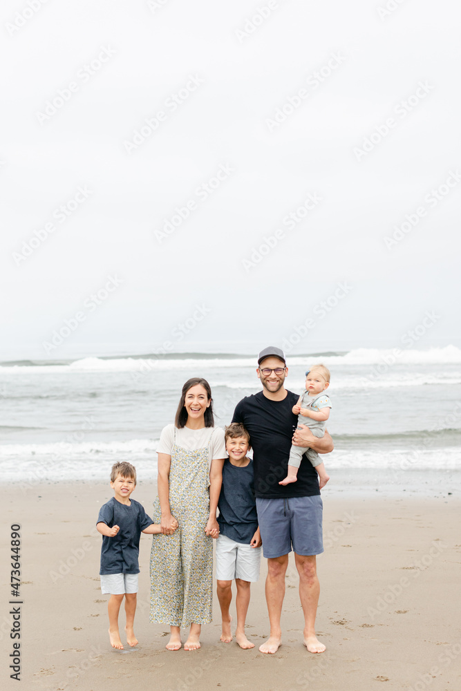 Happy Family Standing on Beach Happy Family Standing on Beach