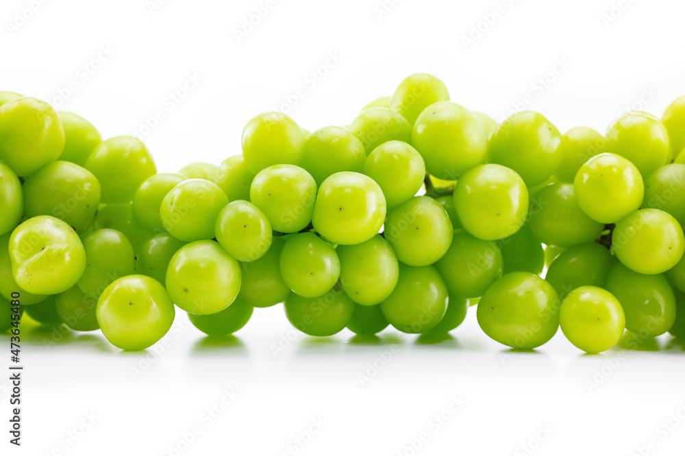 Wall of fresh harvested, plump green grape or muscat grapes. Isolated on pure white background. Wall of fresh harvested, plump green grape or muscat grapes. Isolated on pure white background.