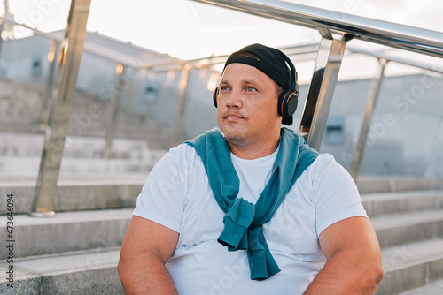 Portrait of a white man sitting on the steps photo