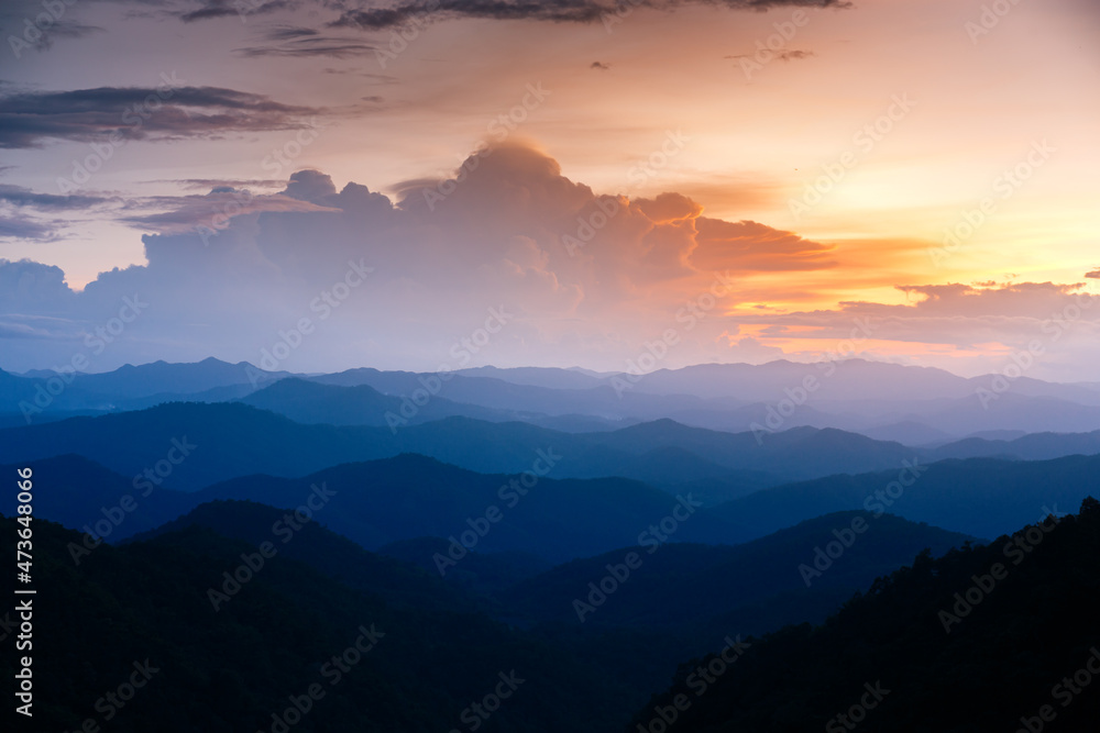 Majestic sunset sky over blue mountains landscape