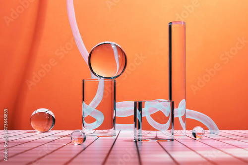 Glass podium minimal scene with glass geometric platform with ribbed acrylic plate on a orange background photo