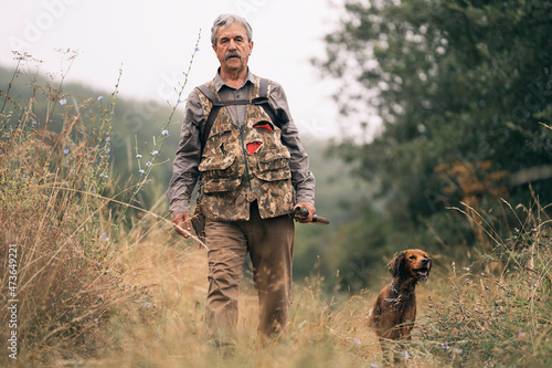 Mature man hunting in the field photo