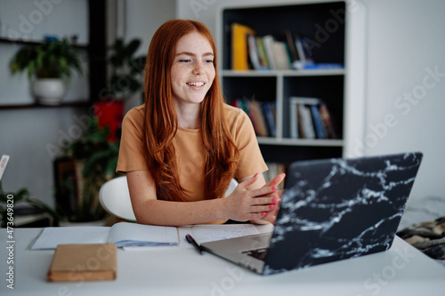 Young girl passing exam remotely at home  photo