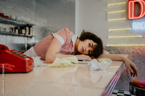 1950s Diner Waitress Laying Over Counter photo