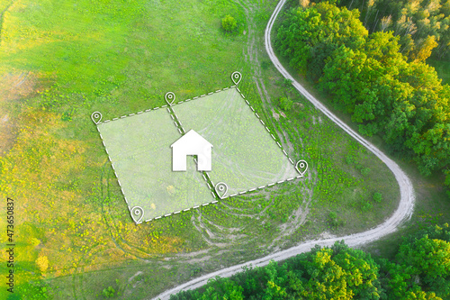 Land Plot for Housing on green field - aerial drone shot. Topographical Marking of two plots of Land for Private Residence House Construction. Land Plot plan with white Graphic House icon. photo