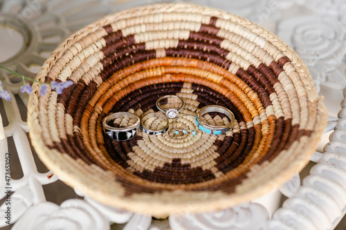 A Woven Basket Containing His and Hers Wedding Rings photo