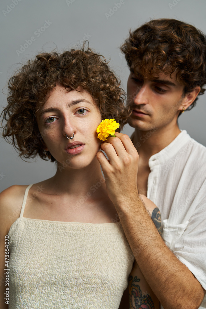 Tender couple with flower in studio Tender couple with flower in studio