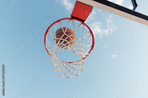 Basketball swishing in net.  photo