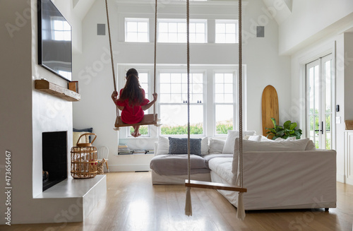 Child on Swinging indoors at home photo