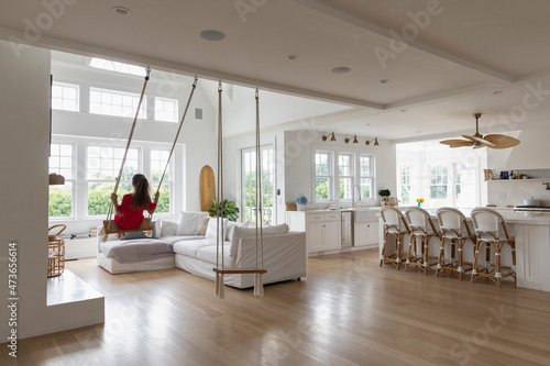 Child in Red Dress  on Swing indoors 