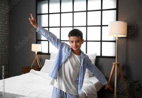 Cute little boy dancing in bedroom