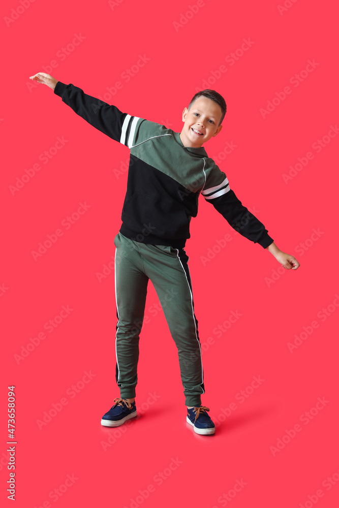 Dancing little boy on color background Dancing little boy on color background