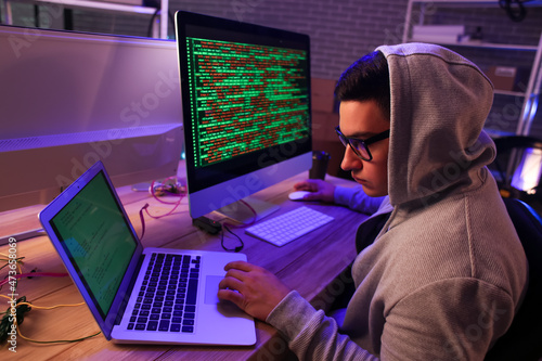 Hacker using computer in da...