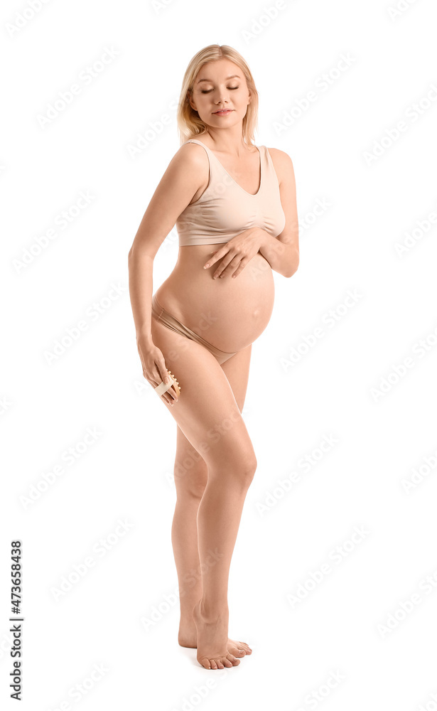 Beautiful pregnant woman with massage brush on white background Beautiful pregnant woman with massage brush on white background