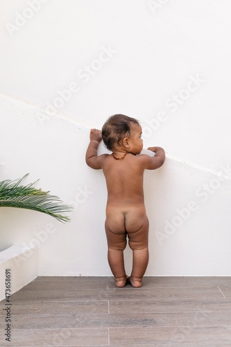 Naked Baby Standing by White Ramp