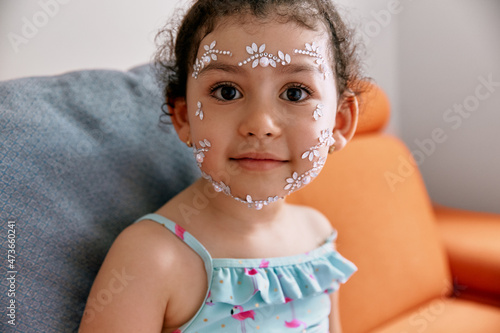Portrait of a little girl with ornaments on her face