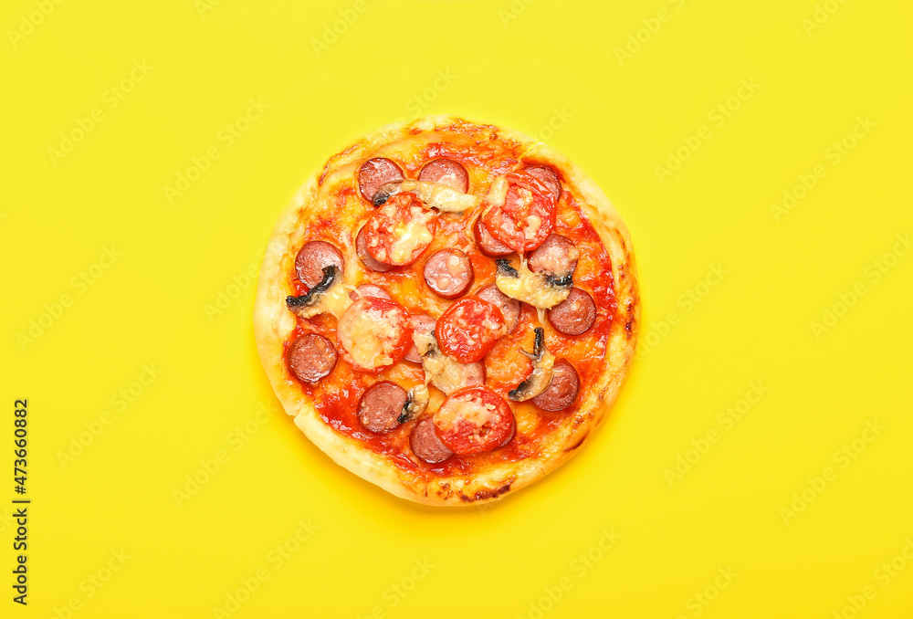 Delicious mini pizza on yellow background Delicious mini pizza on yellow background