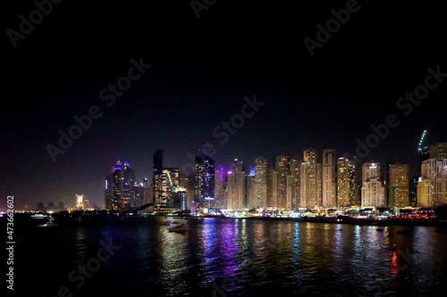 Panoramic view at night of Business Bay district with reflection in sea  UAE. Aerial sky at highest buildings in central Dubai  United Arab Emirates. High quality photo