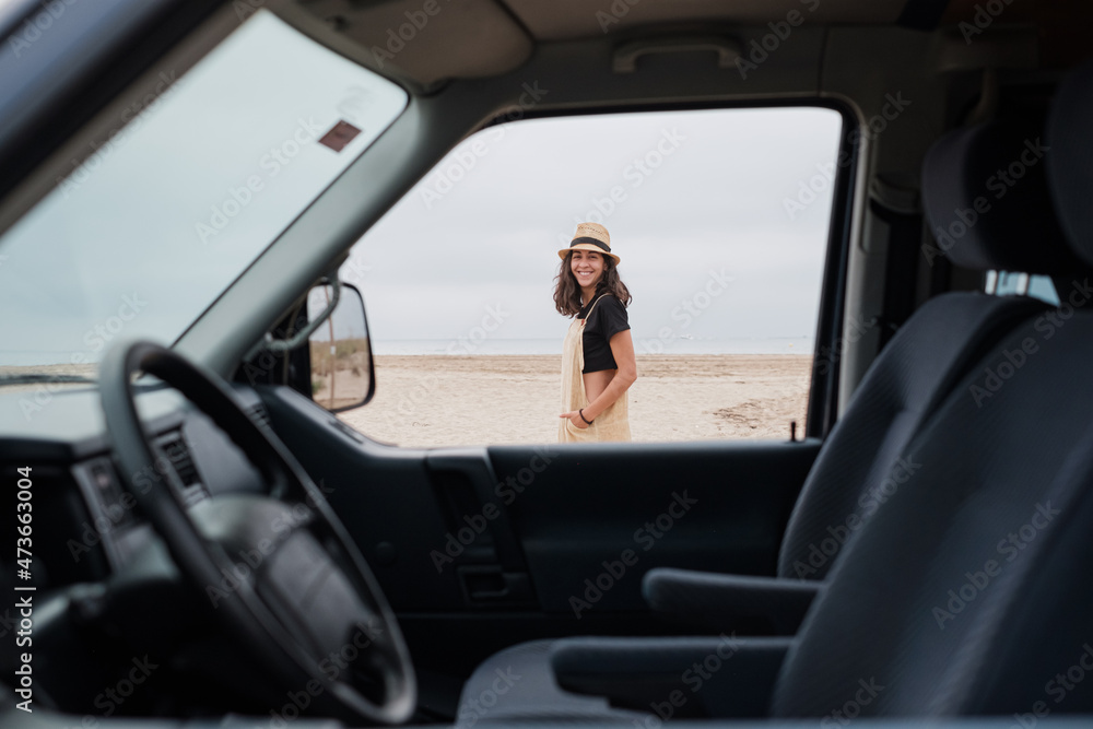 Smiling traveler outside her camper van Smiling traveler outside her camper van