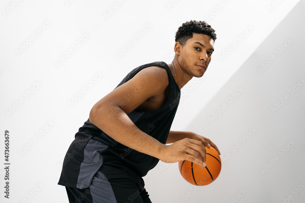 Serious black basketball player in studio Serious black basketball player in studio