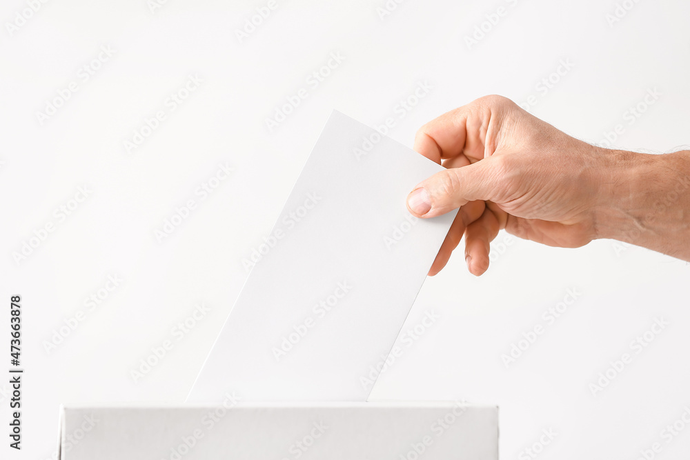 Fototapeta premium Voting young man near ballot box