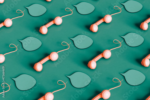 Pattern of pink vintage phone handsets and bubbles
