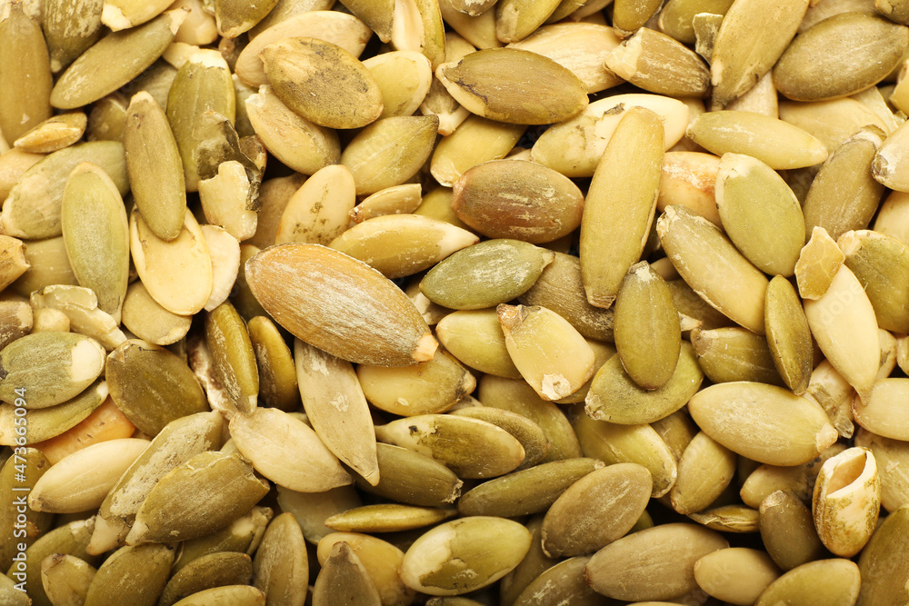 Natural pumpkin seeds as background, closeup Natural pumpkin seeds as background, closeup