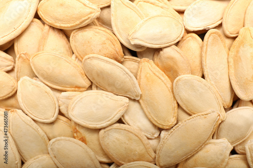 Natural pumpkin seeds as background, closeup