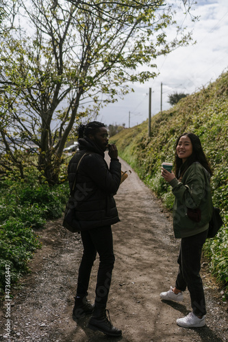 Wallpaper Mural Couple Walking Outdoor With a Coffee  Torontodigital.ca