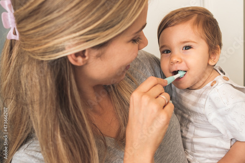 Mother Showing A Baby How To Brush Her Teeth