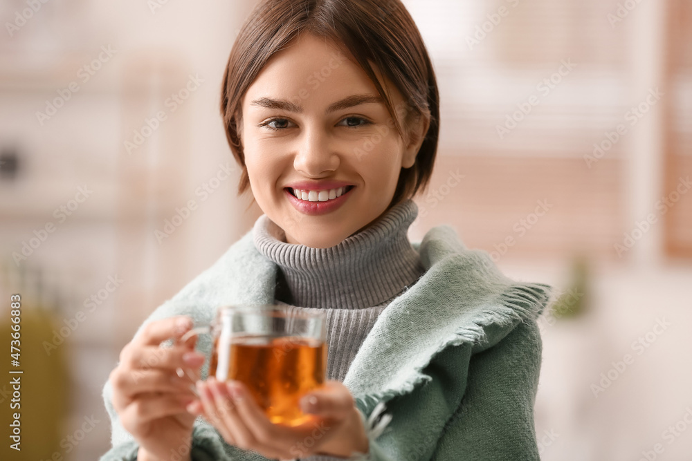 Beautiful young woman drinking tasty tea at home Beautiful young woman drinking tasty tea at home