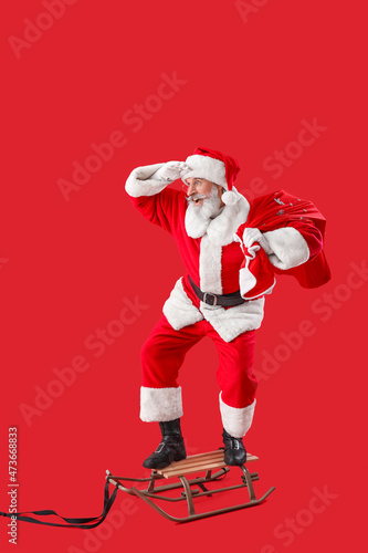 Sledding Santa Claus on col...