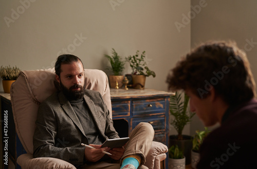 A therapist talking to his patient photo
