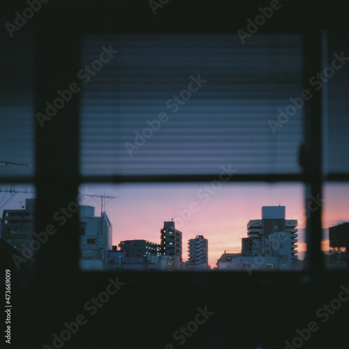 sunset over city through window photo