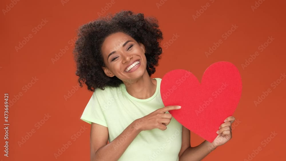 Lady point heart cuddle present isolated dark orange berry color background Lady point heart cuddle present isolated dark orange berry color background