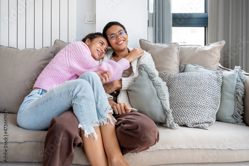 Happy siblings chilling on sofa