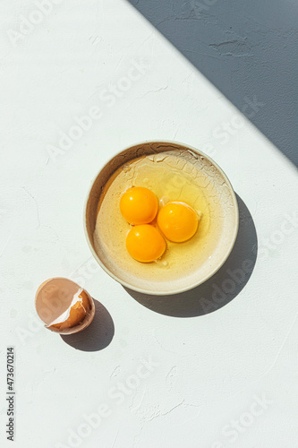 Cracked eggs in a dish photo