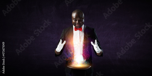 Photos Male illusionist performing tricks . Mixed media